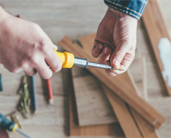 Handyman with a screw driver